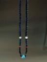 Necklace, single strand polychrome glass beads, one large blue glass bead