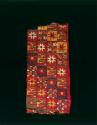 Organic, woven tapestry fragment, brightly colored, flower-like motifs