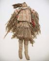 Female doll in fringed buckskin outfit with metal cone jingles.