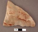 Stone, quartz chipped edged tool with traces of red pigment