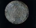 Metal disk ornamented with repousse design