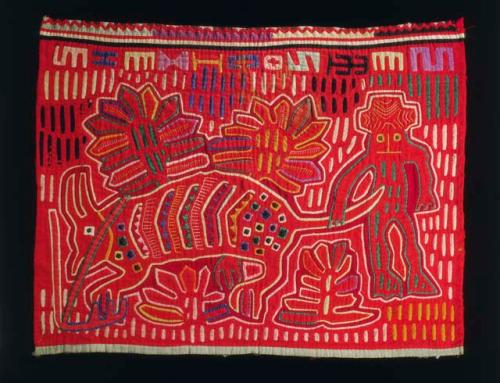 One of a pair of matching molas, depicting an armadillo caught by a hunter