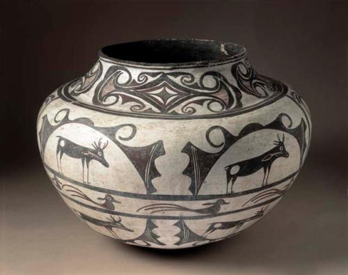 Polychrome pot in black, red, and white. Buck and deer designs in panels