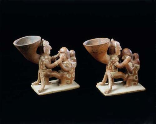 Paired group of figures with attached cups