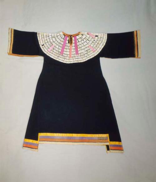 Wool dress made of blue trade cloth. Trimmed on bodice with dentalia shells.