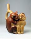 Stirrup spout bottle in form of puma with captive warrior