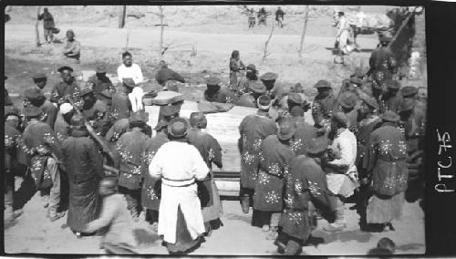 Crowd of people gathered around object