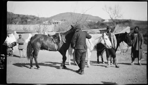 People standing with horses