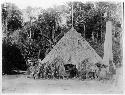 Waiwai men dancing before house