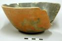 Outcurved bowl; somewhat flattened base, body repair, chipped rim, small fireclo