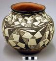 Pottery vessel. Black and white painted decoration.