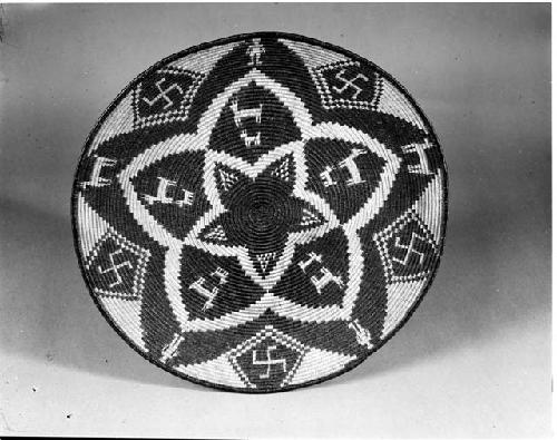 Coiled tray with animal, person, and swastika motif