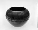 Black-on-black ceramic bowl; feather motif