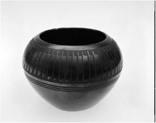 Black-on-black ceramic bowl; feather motif