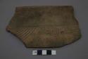 Large rim sherd. Incised decoration with shite filling.