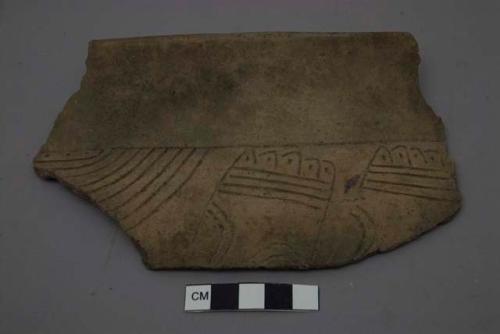 Large rim sherd. Incised decoration with shite filling.