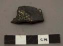 Small fragment of black polished pottery  - white filled punctures