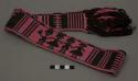 Waistband, predominantly black and pink, animal and human figures within design