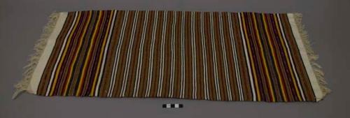 Textile with tan, white, yellow, red, green, and navy blue thin bands