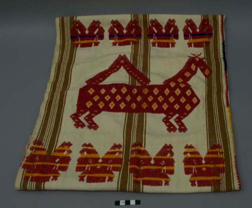 Shawl/headdress, two panels sewn together, white ground with red and orange animal form brocade. The white ground has darkened over time and has a number of stains.