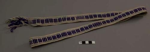 Thin band, white ground with two thin blue stripes and central purple woven design