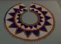 Beaded collar, beaded circular design, white ground with blue, red, orange, and green triangles and trim