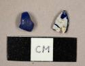 Blue glass fragment with opaque white decoration and blue plastic bead fragment