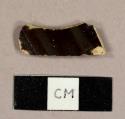 Buff earthenware sherd with brown glaze on interior, possibly manganese mottled