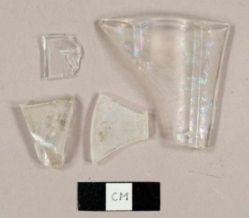 Colorless curved glass fragments, including one rim sherd to a tumbler and one frosted fragment