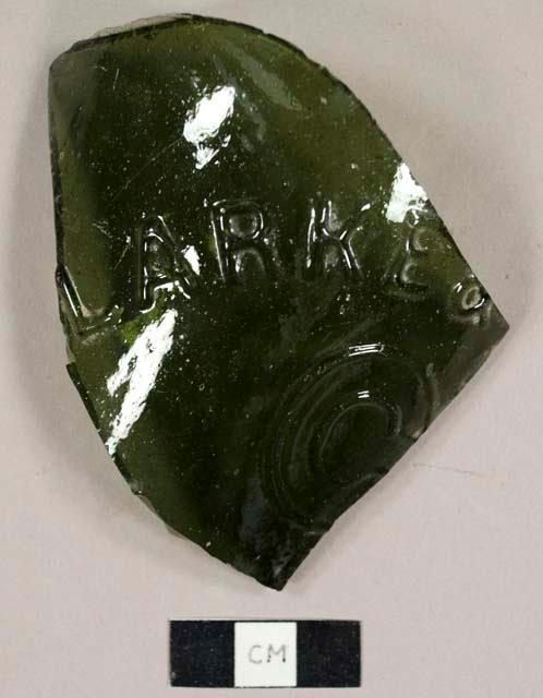 Olive green bottle glass fragment with "LARKE &" and "C" embossed  on exterior