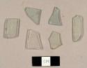 Aqua and colorless flat glas fragments, including one with three perpendicular scratches on one side