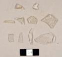 Colorless bottle glass fragments, including four fragments from a hurricane lamp and one fragment with "ARD / C" embossed on one side