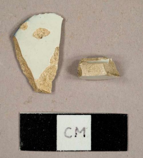 Pearlware sherds, including a base fragment of a mug and a rim sherd of a shell-edged blue pearlware plate