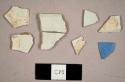 Pearlware sherds, including one rim to a teacup with an impressed design on interior and one sherd with blue glaze, possibly annular ware