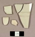 White salt glazed stoneware, including two body sherds to a mug with incised ribbed design and one rim sherd to a cup