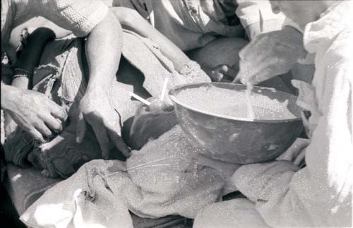 Person having a plaster cast mold made of their face by two expedition members, close-up