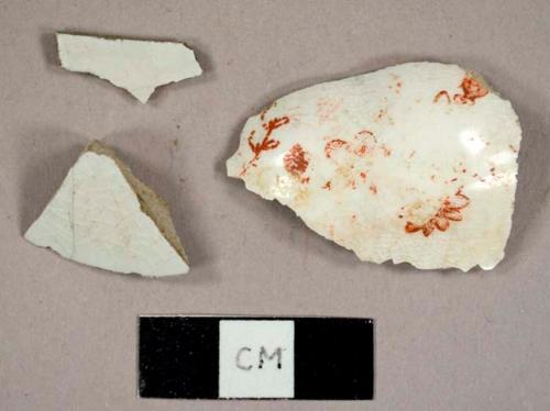 Two ironstone sherds and one whiteware sherd with yellow and red overglaze decoration