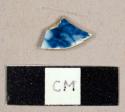 Pearlware sherd with blue transfer print on one side, possibly flow blue