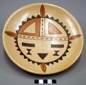 Ceramic plate, stylized black and red on buff interior, polishing striations