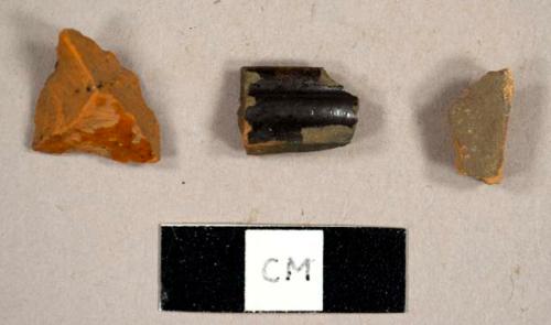 Refined redware sherds, including one with lead glaze and one mug rim sherd with a lusterous exterior and greenish glaze on interior