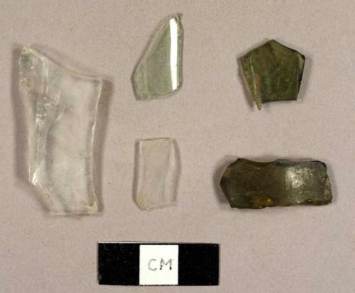 Colorless, aqua, and olive green curved glass fragments, including one from a faceted tumbler