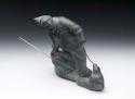 Stone carving - man spearing seal