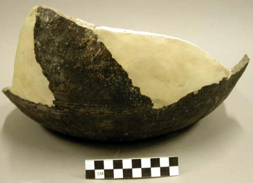 Base of large pottery cook pot showing basketry impression