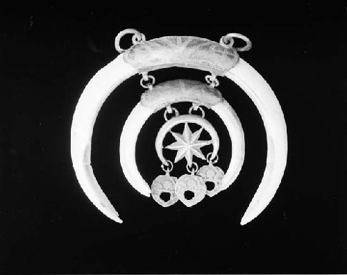 Amulet of boar's tusk, mounted in silver