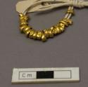 Gold beads from about neck of skeleton no. 3