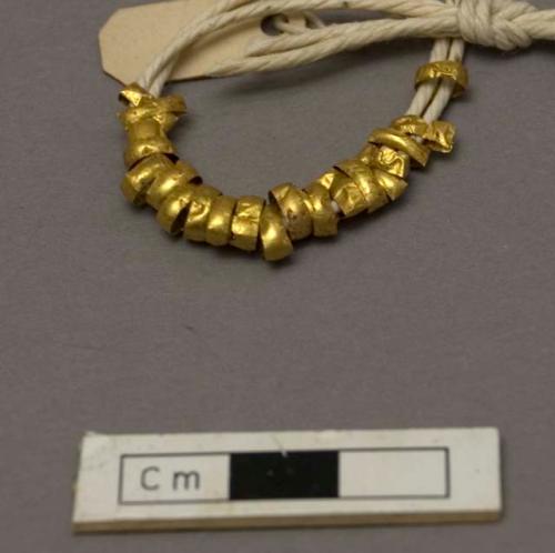 Gold beads from about neck of skeleton no. 3