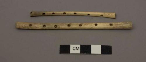 Organic, bone flute (?), six perforations along shaft