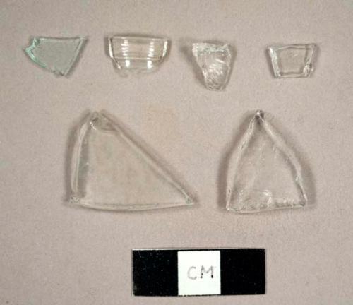 Colorless curved glass fragments, including one lip sherd for a small bottle, possibly pharmaceutical