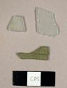 Flat glass fragments, including two colorless and one green fragment