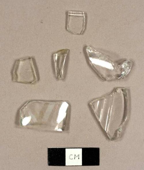 Colorless bottle glass, inculding one ribbed design and one rolled rim possibly from a cup